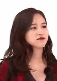 a close up of a woman making a funny face with her eyes closed .