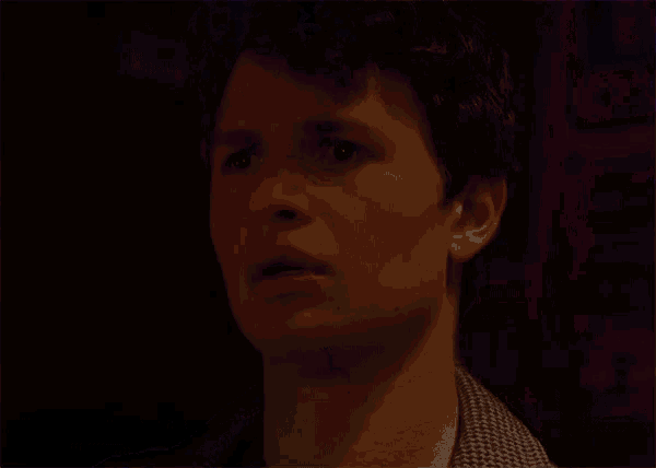 a close up of a man 's face with a purple light behind him