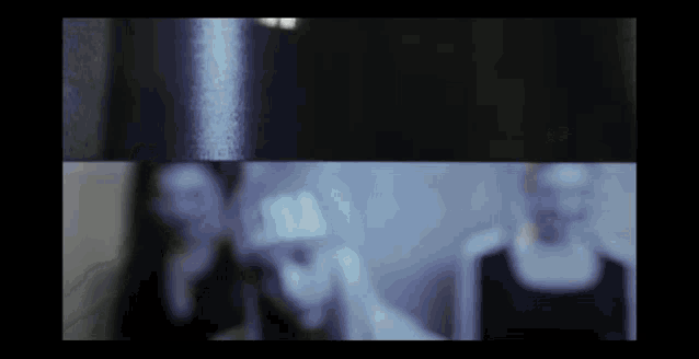 a blurry picture of two women standing next to each other
