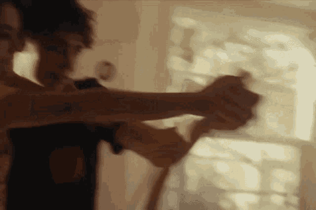 a blurry picture of a man and woman dancing in front of a window .