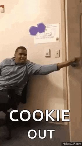 a man is sitting in a chair in front of a door with the words cookie out on it .