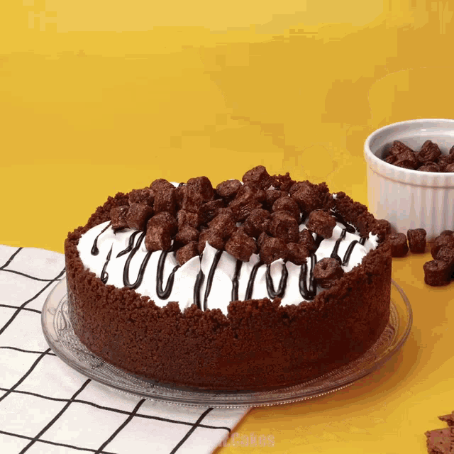 a chocolate cake with a white frosting and chocolate chips