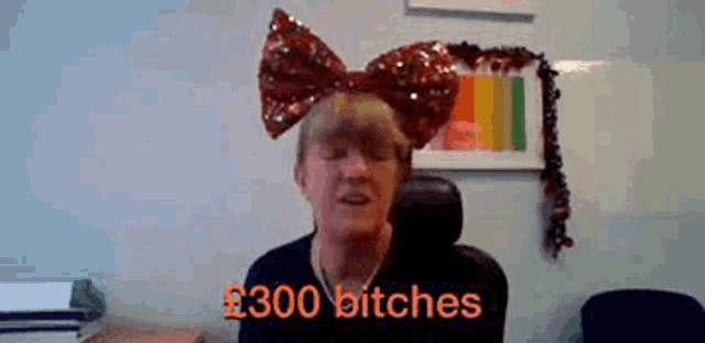 a woman wearing a large red bow on her head says 300 bitches