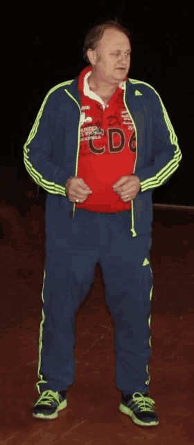 a man wearing a red sweatshirt that says cdc on it