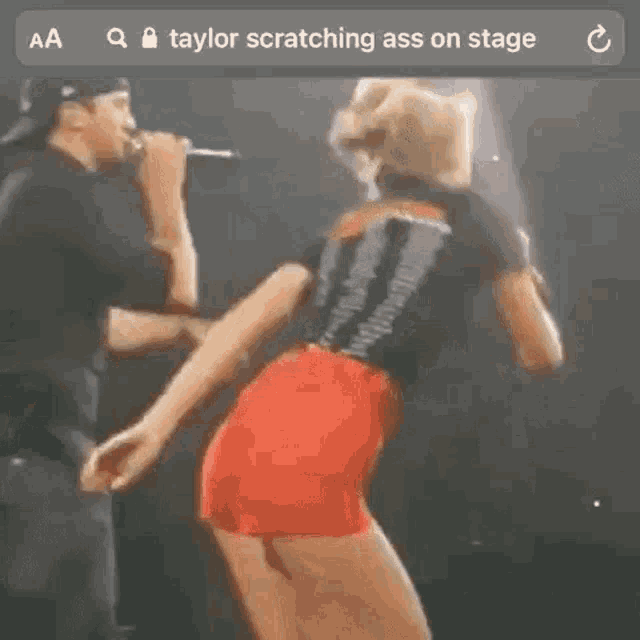 taylor swift is scratching her ass on stage .