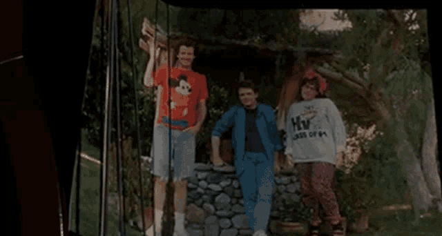 a group of people are standing next to each other in front of a tree house .