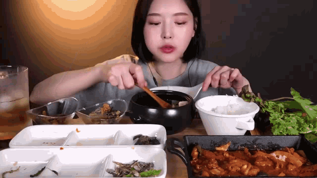 a woman is sitting at a table eating food