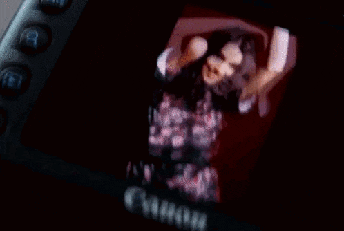 a blurry picture of a woman is on a camera screen