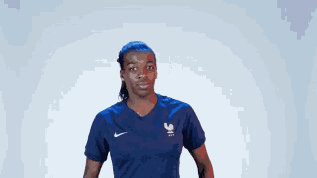 a woman is wearing a blue nike shirt with a rooster on it