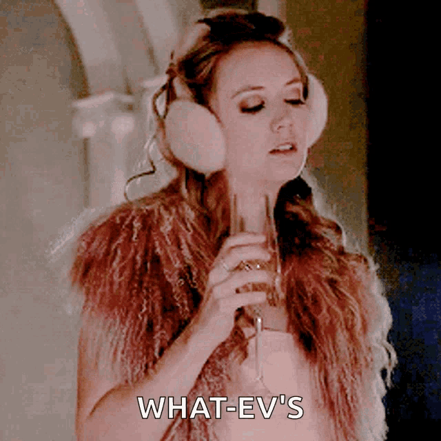 a woman wearing ear muffs is holding a glass of champagne and says what-ev 's