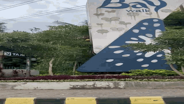 a large blue and white sign that says walk on it