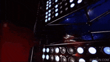 a gif from gifrun.com shows a fireworks display on a stage
