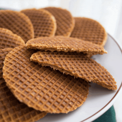 a white plate topped with a stack of wafers