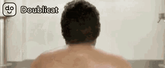 a man is taking a bath in a bathtub with the words doublecat on the bottom