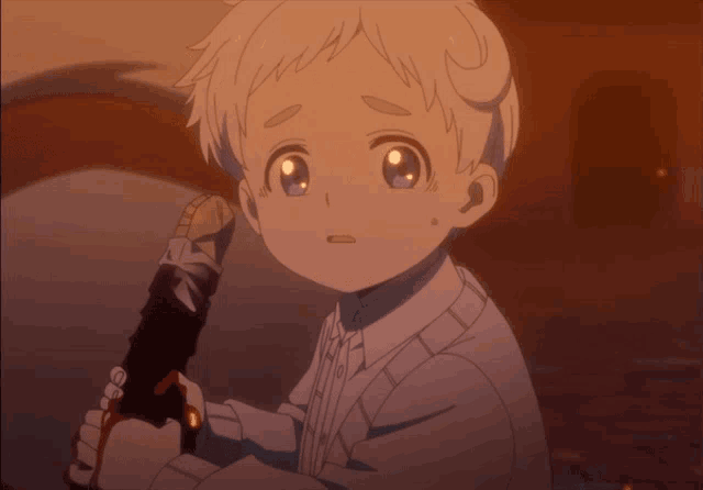 a young boy is holding a microphone and looking at the camera