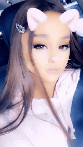 a close up of a woman wearing a cat ear filter