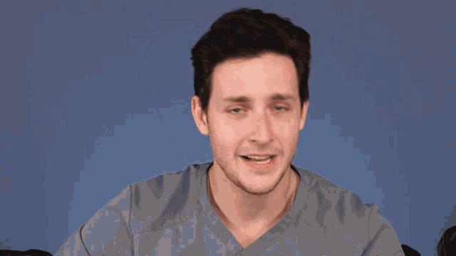 a man with braces on his teeth is smiling and the word sigh is behind him