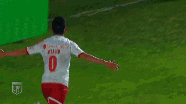 a soccer player wearing a white jersey with the number 9 on it