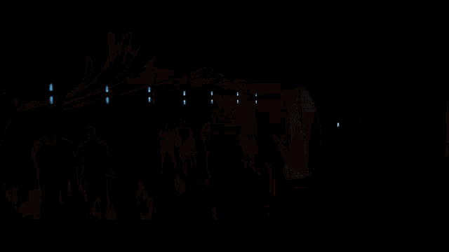 a row of robots are lined up in a room with a sign that says ' tc ' on it