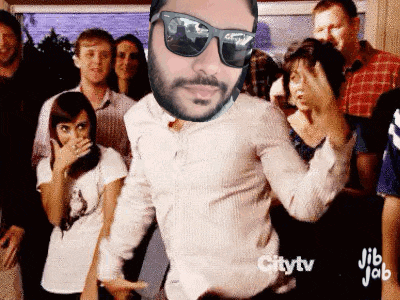 a man with a beard and sunglasses is dancing in front of a crowd .