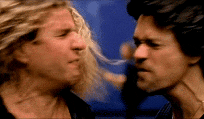two men are having a fight and one of them is blowing his hair