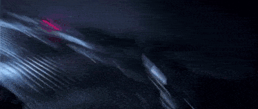 a person is walking down an escalator in a dark room .