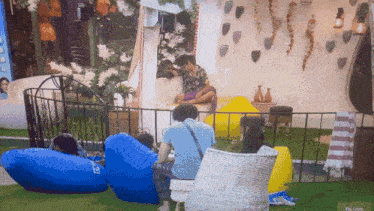 a group of people are sitting on bean bag chairs in a room