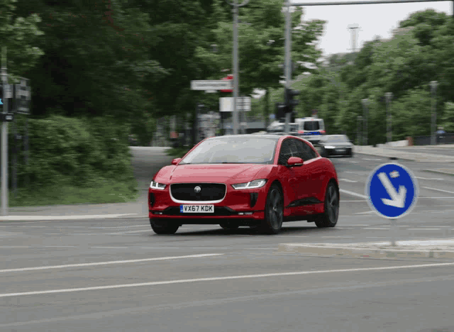 a red car with a license plate that says xk67 kdz