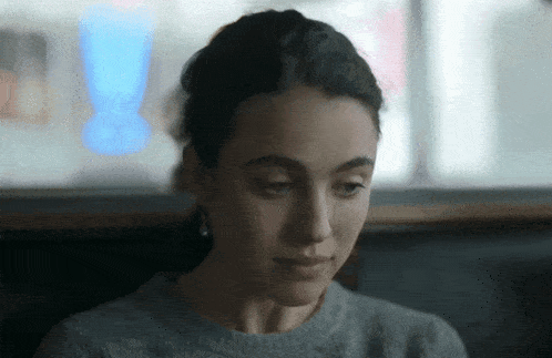 a close up of a woman 's face with a blurry background .