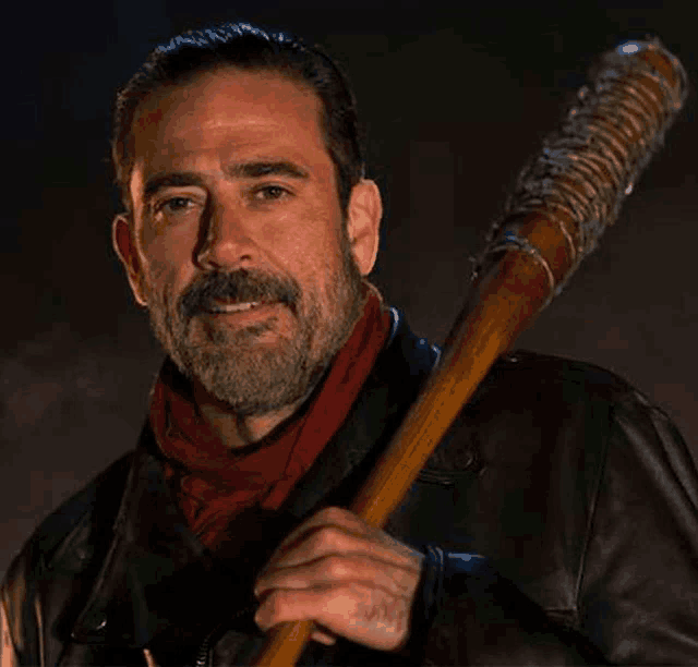 a man with a beard and mustache is holding a baseball bat .