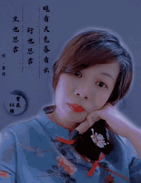 a woman wearing a blue shirt with flowers on it looks at the camera
