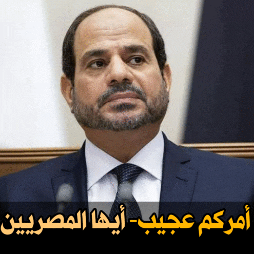 a man with a beard wearing a suit and tie with arabic writing above him