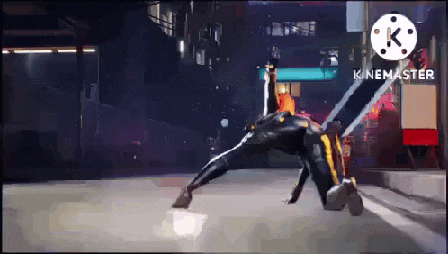 a person in a superhero costume is doing a trick on the ground .