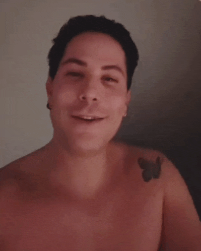 a shirtless man with a tattoo of a butterfly on his shoulder