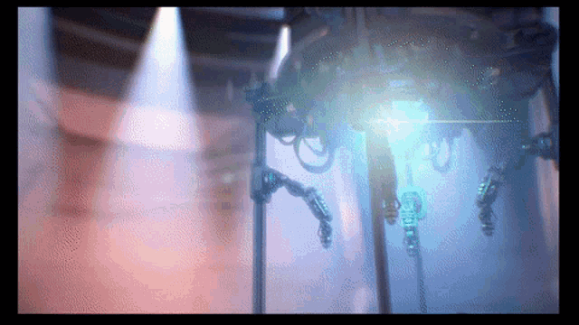 a blurred image of a machine with a light shining on it