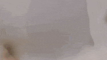 a person holding two white pillows in front of their face