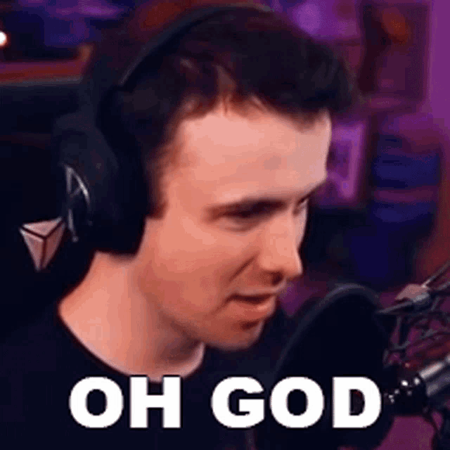 a man wearing headphones is sitting in front of a microphone and saying oh god .