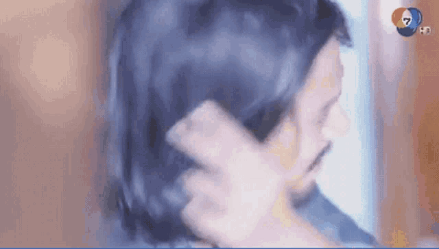 a close up of a person holding another person 's hair .