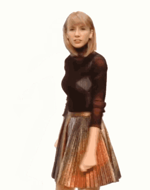 a woman in a pleated skirt is dancing in front of a white background