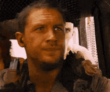 a close up of a man 's face with a beard in a car .