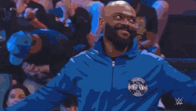 a man wearing a blue jacket with the word wrestling on the back