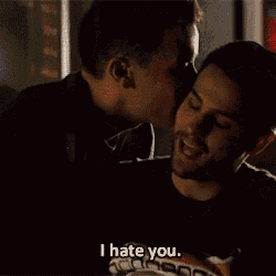 two men are hugging each other and one of them says i hate you .