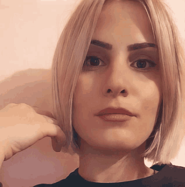 a close up of a woman 's face with a black shirt on
