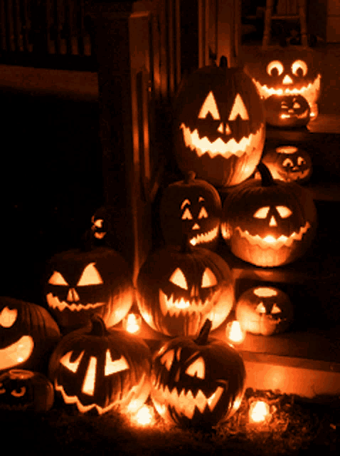 a bunch of pumpkins with faces carved on them
