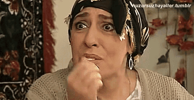 a woman wearing a head scarf and earrings is making a funny face and has a tumblr link below her