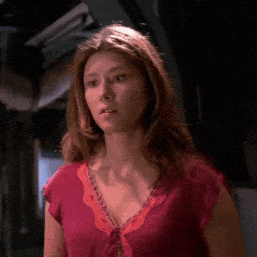a woman in a pink top with a lace collar