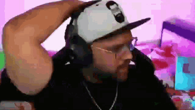 a man is wearing headphones and a hat with the number 8 on it