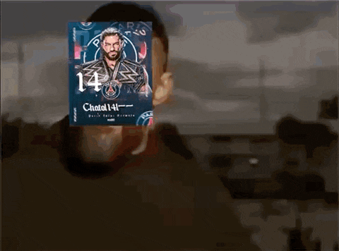 a man is holding a poster of roman reigns over his face