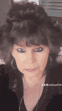 a close up of a woman 's face with the hashtag judyraye5 on the bottom
