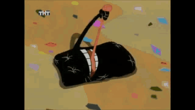 a cartoon character is laying on the ground with the letters tht on the bottom right